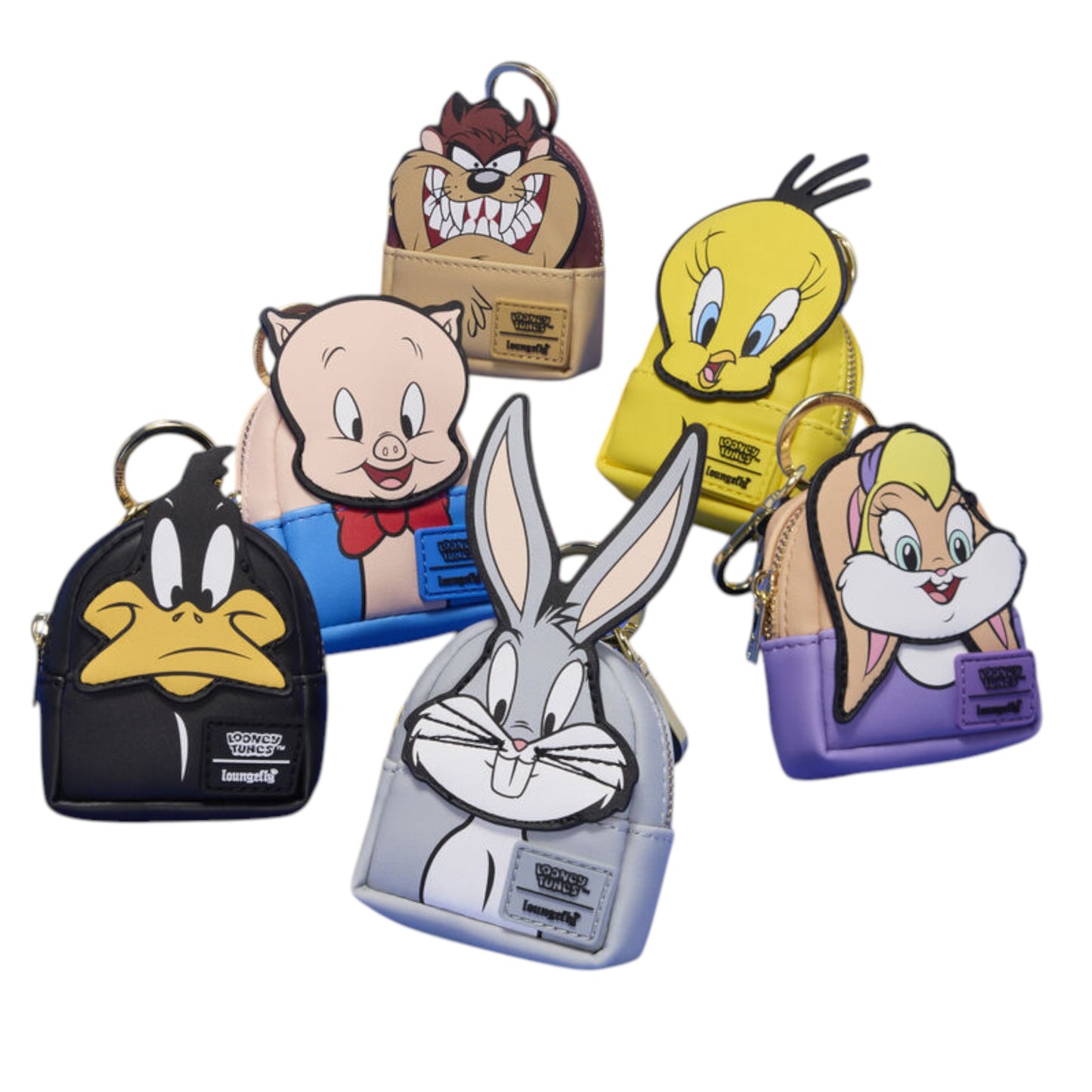 Five mini backpack keychains featuring Looney Tunes characters, including Bugs Bunny, Tweety Bird, Porky Pig, Daffy Duck, Lola Bunny, and Tasmanian Devil, displayed against a solid white background.
