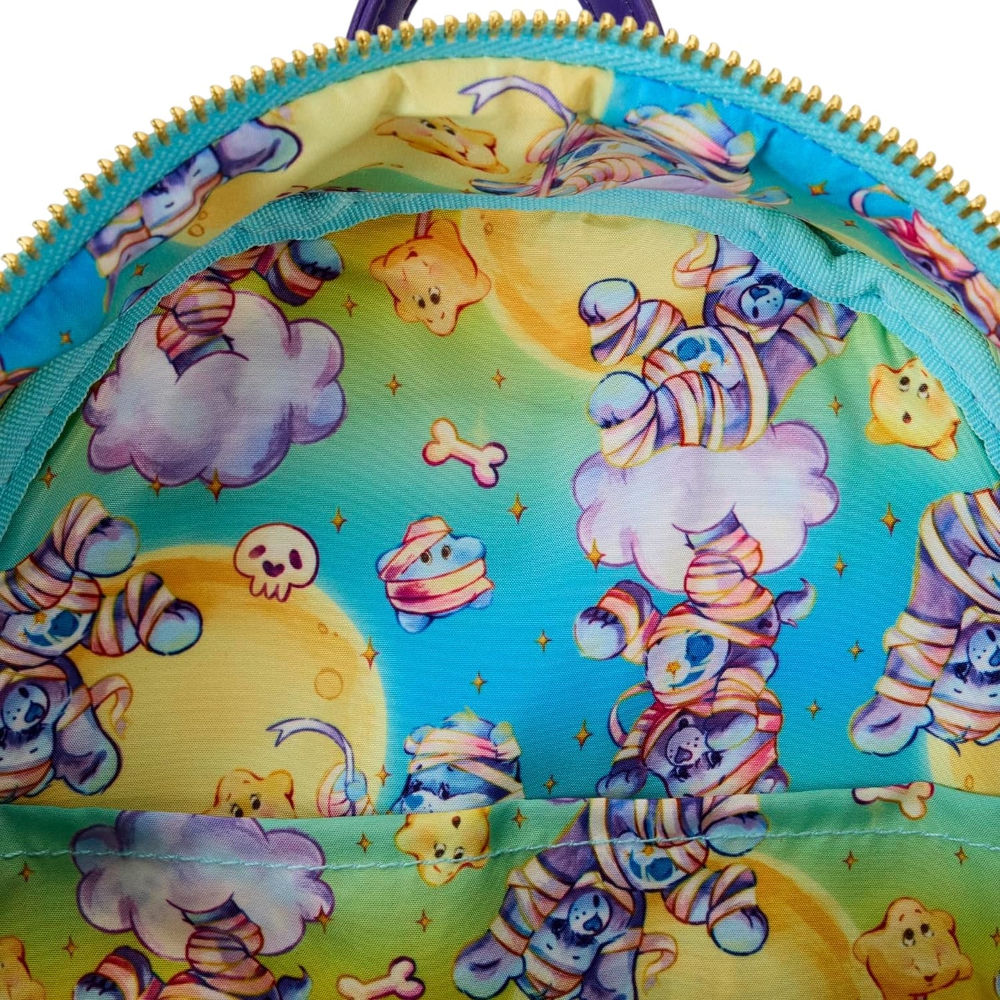 Colorful Care Bears x Universal Monsters Bedtime Bear Mummy Mini Backpack with Care Bear character wrapped as a mummy with character pattern on a blue background