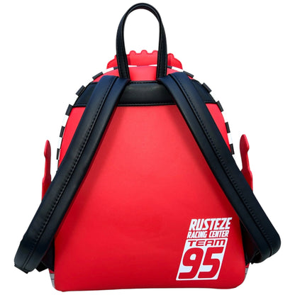 Red Mack backpack with black straps and 'Rust-eze Racing Center Team 95' text on a white background