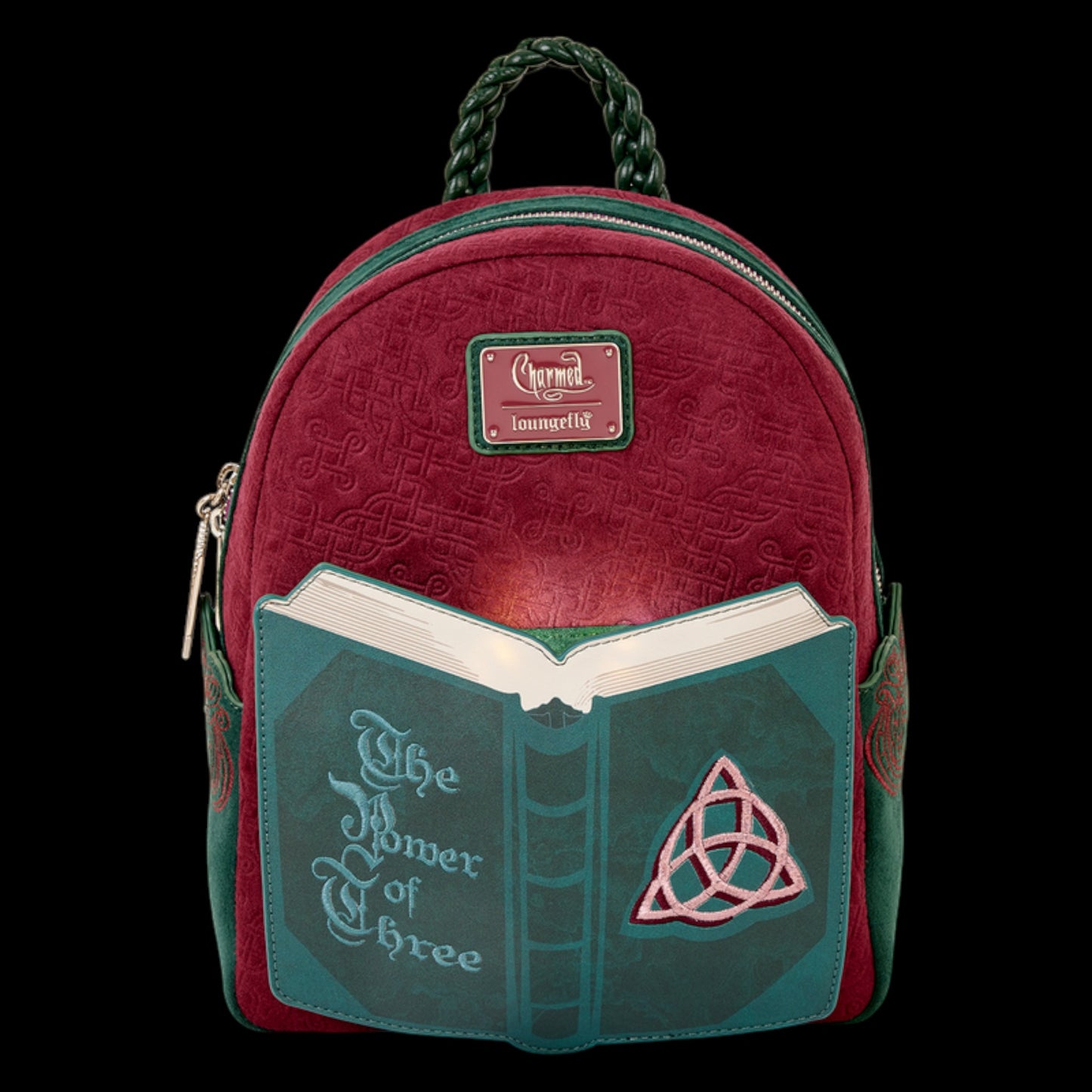 Glowing Red and green Loungefly Paramount Charmed Light-Up Mini Backpack with book design and 'The Power of Three' text on a white background