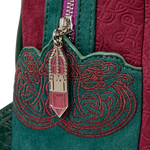 Close-up of a textured fabric with a decorative zipper and floral charm.