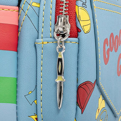 Close-up of Loungefly Child's Play Chucky Cosplay Mini Backpack with  a knife-shaped zipper charm on a blue background