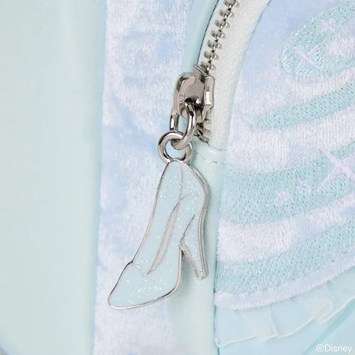 Close-up of a high-heeled shoe zipper charm on a Cinderella Mini Backpack with Disney logo.
