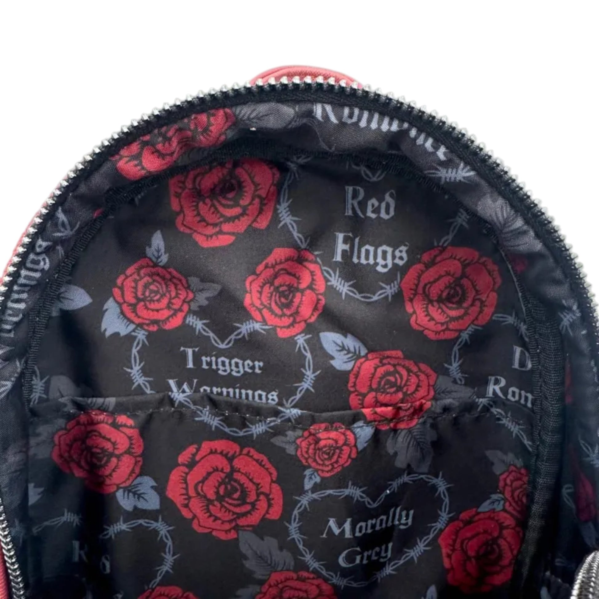 Inside of Loungefly Dark Romance Mini Backpack with red roses and 'Red Roses', Trigger Warning', Morally Grey' and Dark Romance' text on a black background