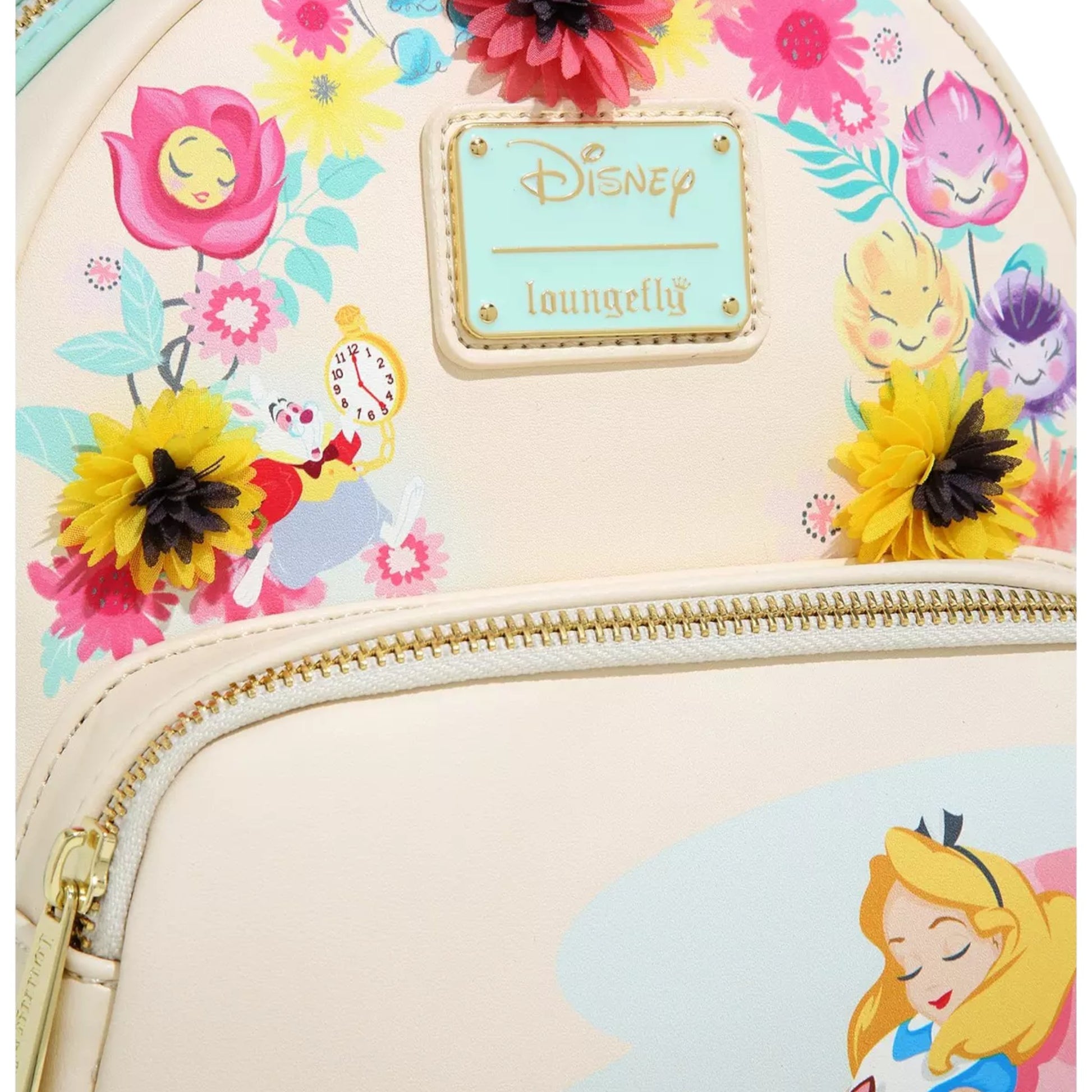 Close-up of Alice in Wonderland Garden Flowers Mini Backpack with Alice character design laying against a mushroom with floral elements and a Disney Loungefly branded logo on a white background