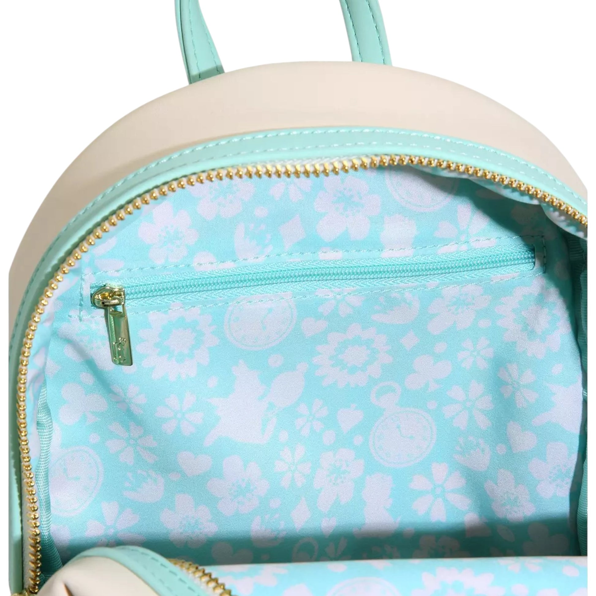 Close-up of Alice in Wonderland Garden Flowers Mini Backpack with with character and floral patterns on a light blue interior