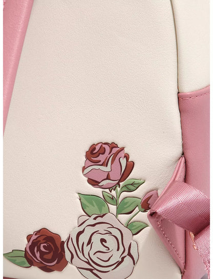 Close-up of Loungefly Disney Beauty and the Beast Floral Sketched Portrait Mini Backpack with pink roses and a bow on a light background