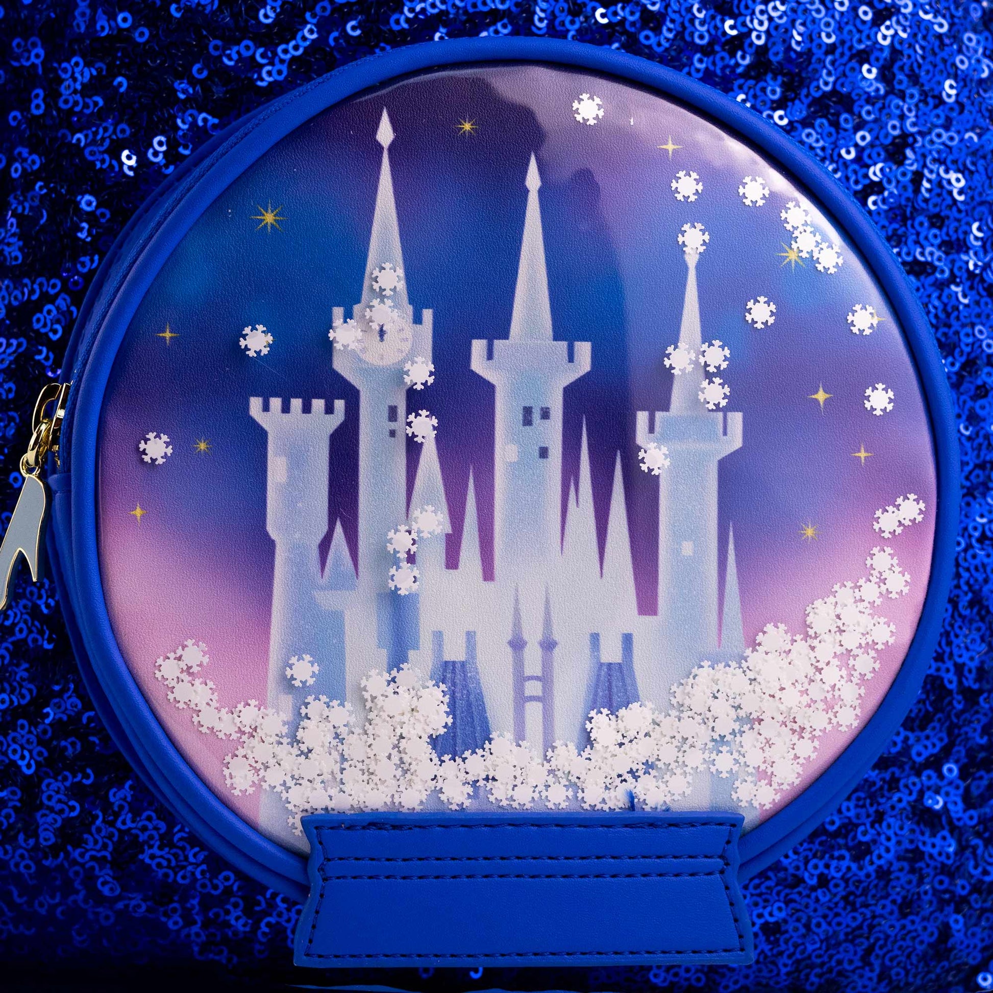 Close-up of Loungefly Disney Cinderella Castle Snow Globe Sequin Mini Backpack with Cinderella Castle and a silver slipper zipper charm on front on a white background