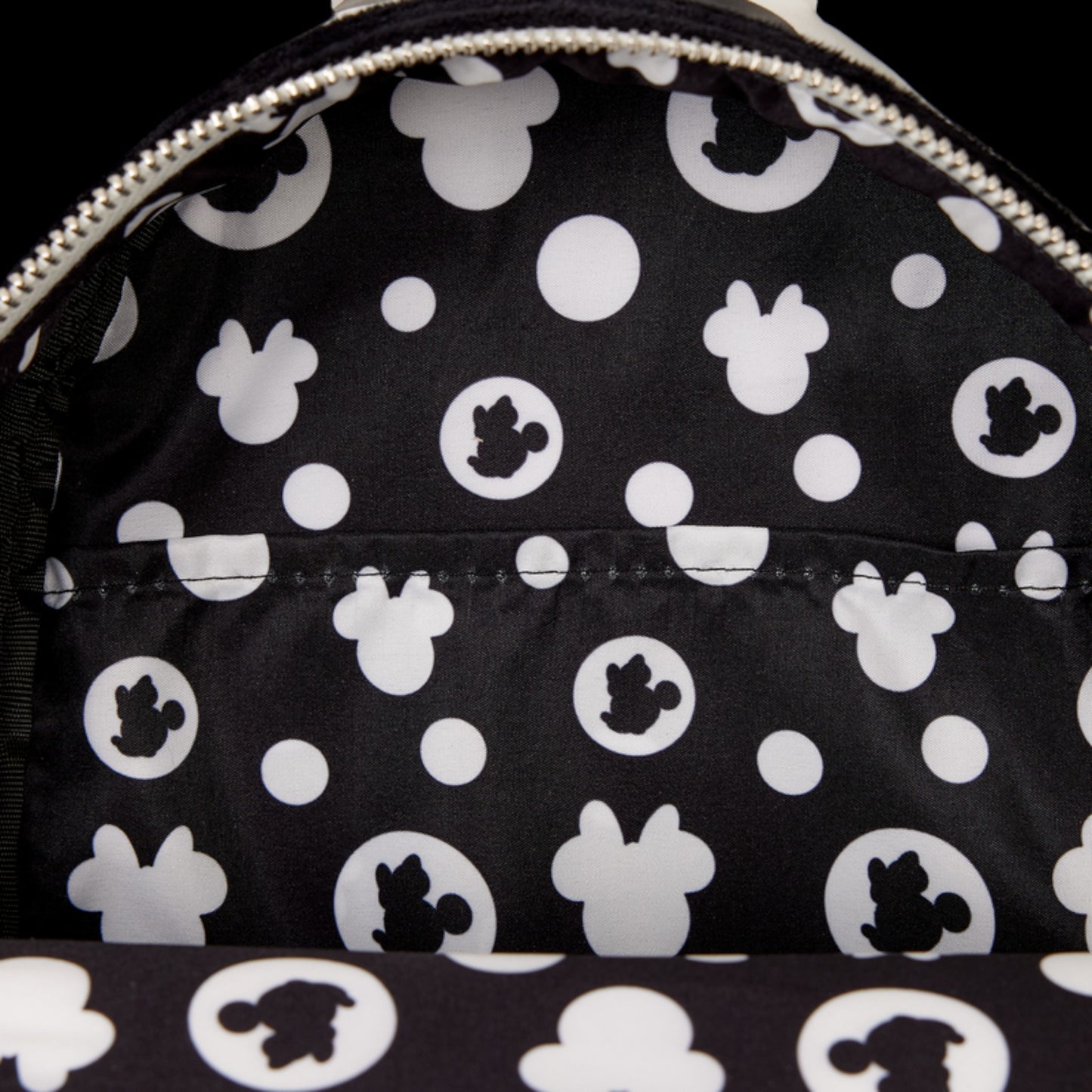 Black and white backpack with black and white Minnie Mouse head pattern