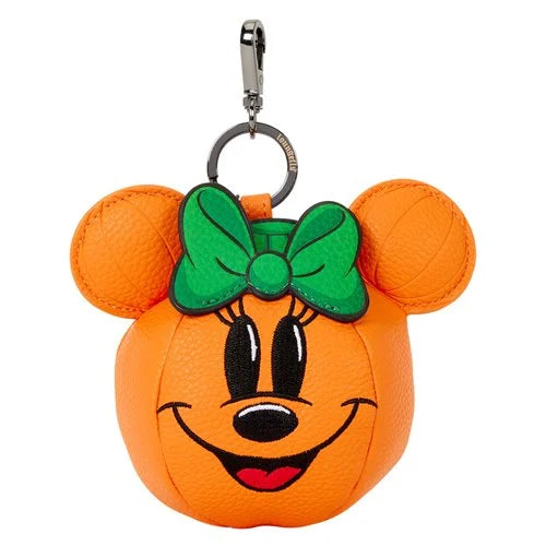 An orange pumpkin-shaped coin purse designed like Minnie Mouse's head, featuring a green bow on her forehead, black embroidered eyes and nose, and a silver metal clasp at the top, shown against a plain white background.
