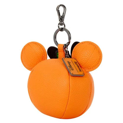 An orange textured leather Mickey Mouse-shaped keychain bag with two round ears, a silver metal clasp, and a Disney tag on a white background.