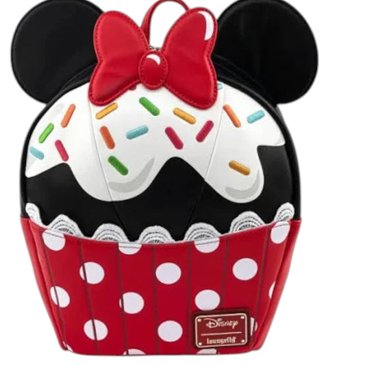 Backpack designed like a cupcake with Minnie Mouse ears and bow, featuring colorful sprinkles and polka dots on a white background.