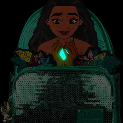 Green Loungefly Disney Moana Heart of Te Fiti Sequin Glow Mini Backpack with Moana Character design holding a glowing green gem surrounded by flowers on a white background 