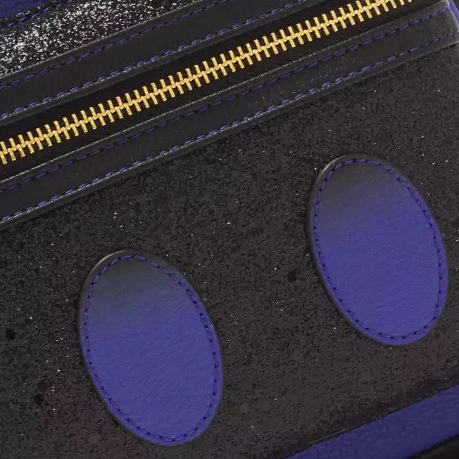 Close-up of a black pouch with gold zipper and purple circular accents