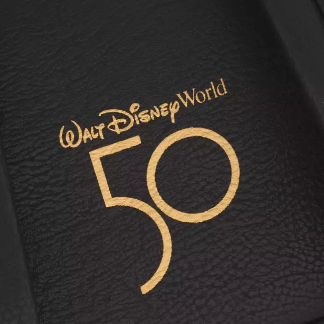 Walt Disney World 50th anniversary logo on a textured black surface