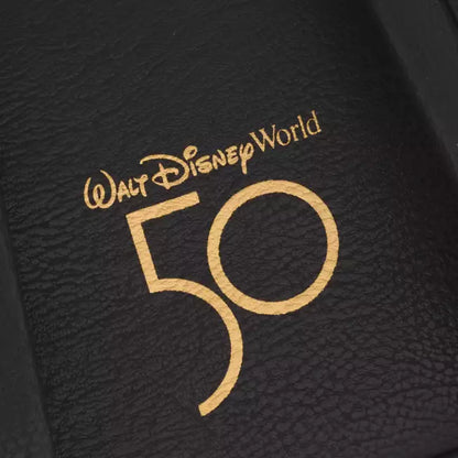 Walt Disney World 50th anniversary logo on a textured black surface