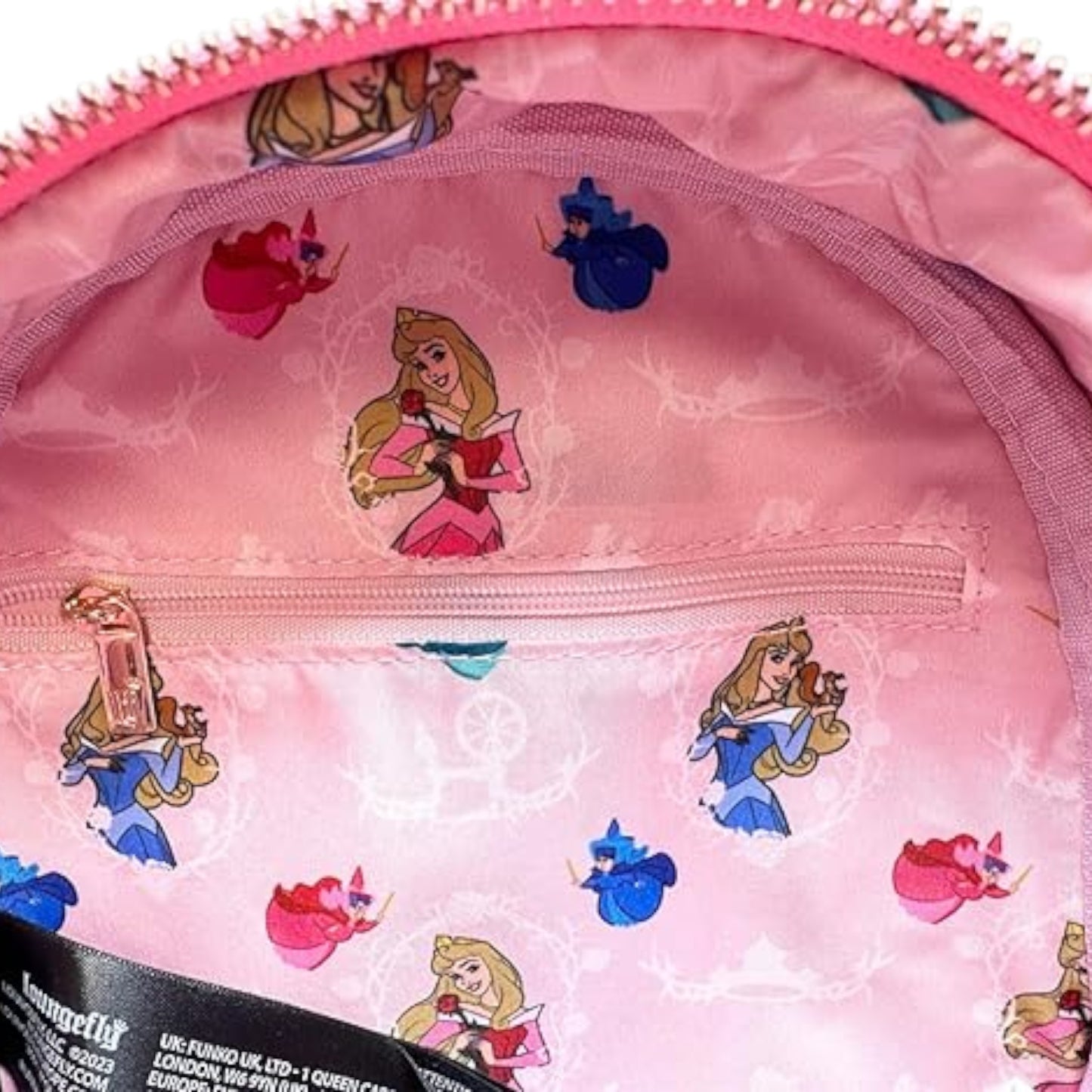 Pink backpack with Disney princess Aurora characters on a pink background