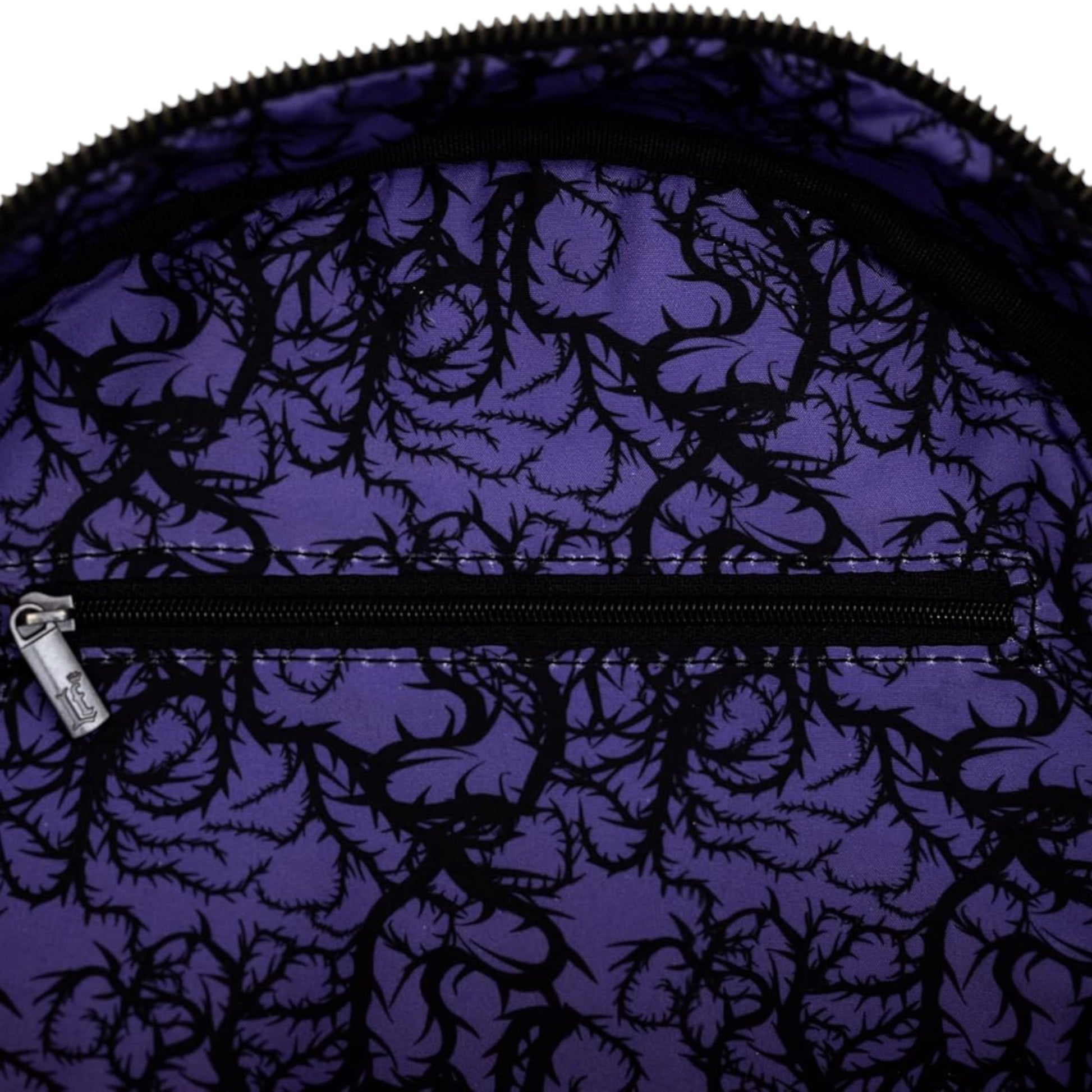 Inside of Purple Loungefly Disney Sleeping Beauty Maleficent Transformation Mini Backpack with purple fabric with black floral pattern and zipper 