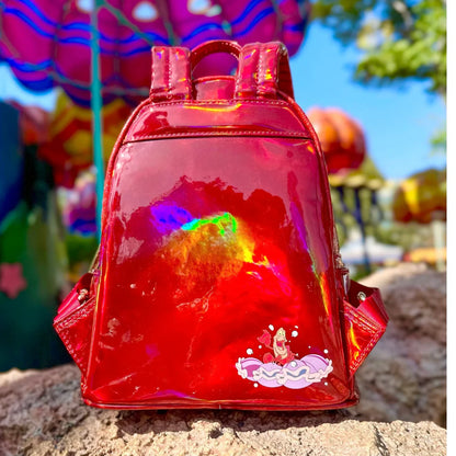 Red holographic backpack with The Little Mermaid Sebastian Metallic  design on a stone surface with colorful background
