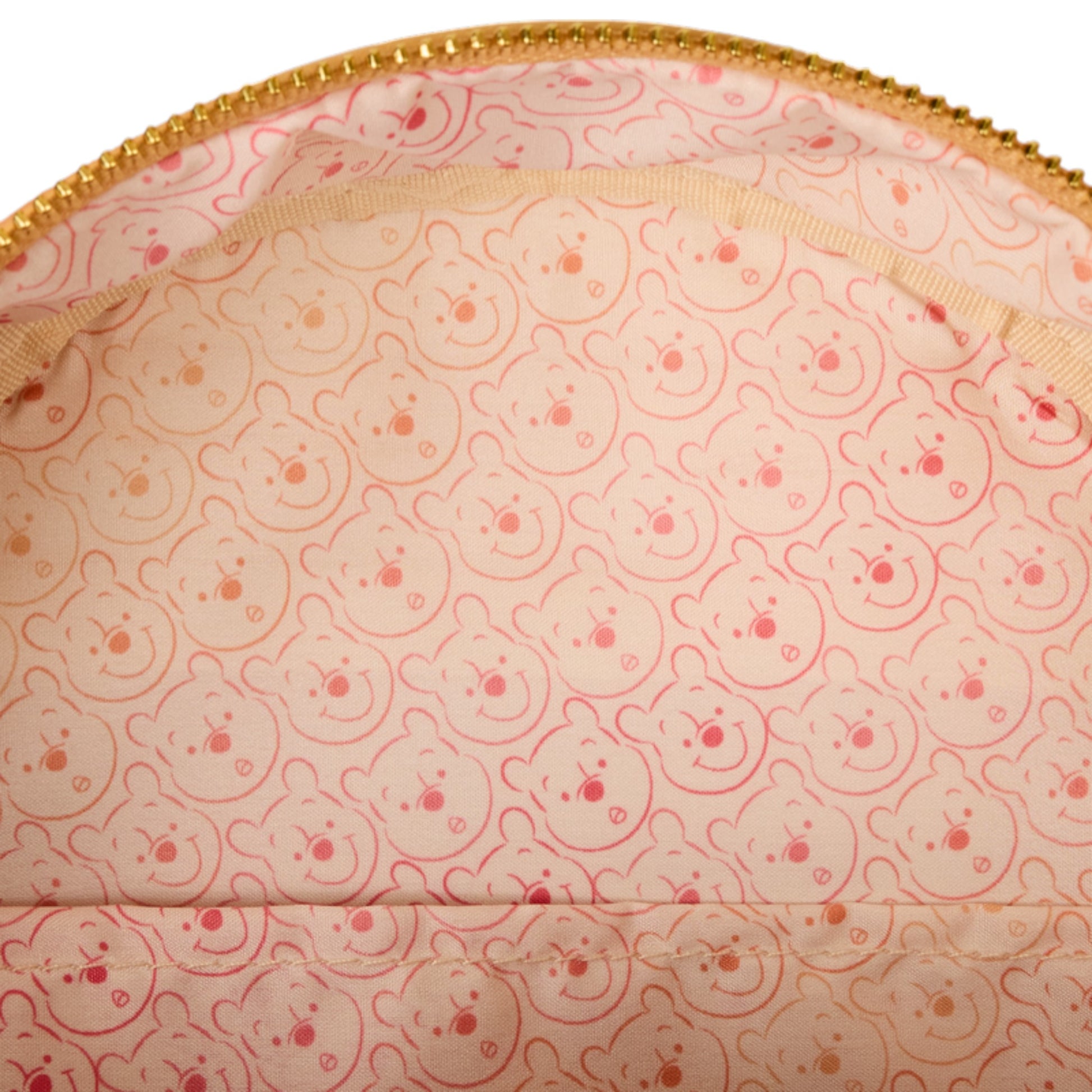 Close-up of the inside of a pink Winnie the Pooh Cosplay Sequin & Glitter Mini Backpack with Winnie the Pooh face pattern and gold zipper.