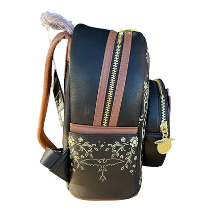 Black Toothless backpack with floral embroidery and gold accents on a white background