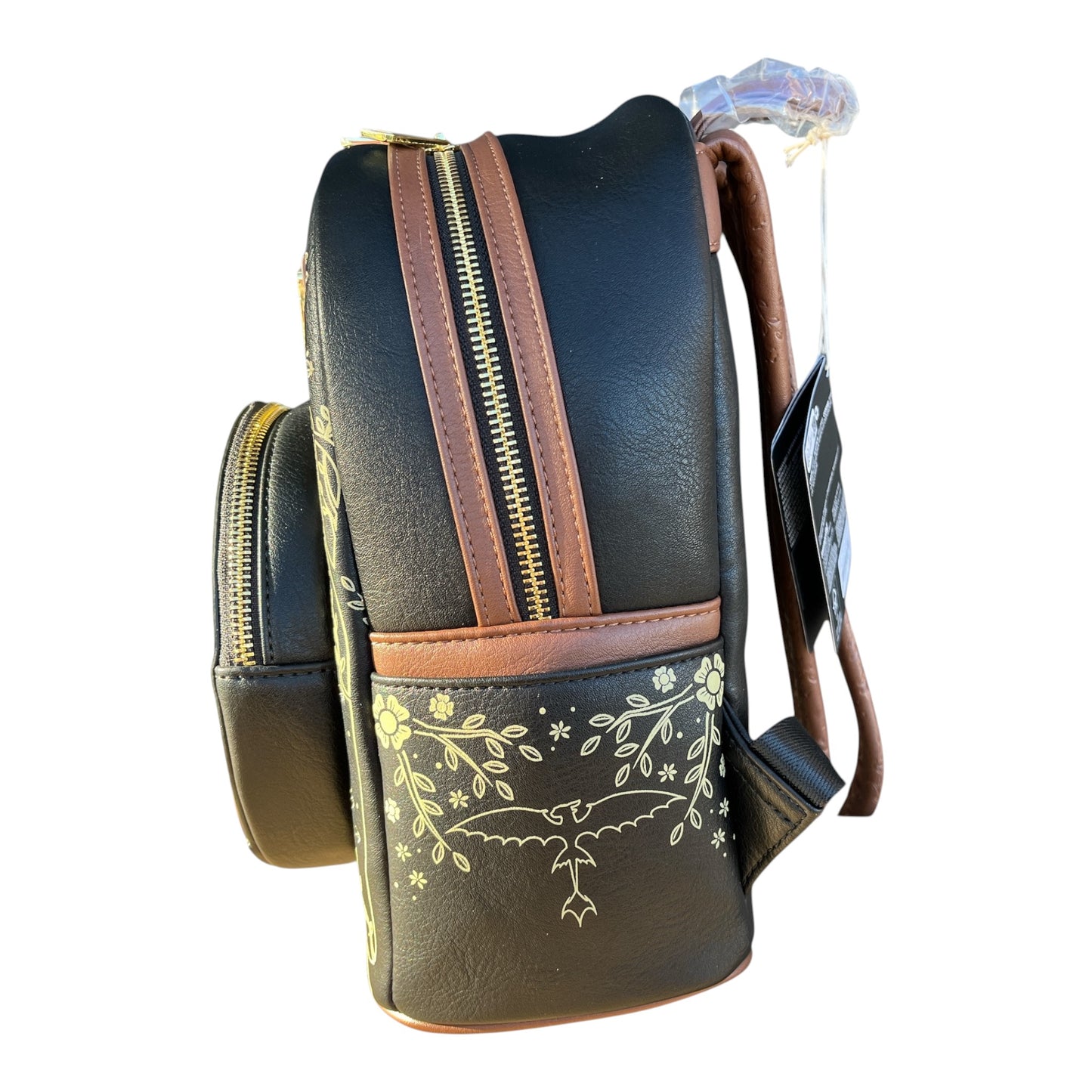 Black Toothless backpack with brown accents and floral design on a white background