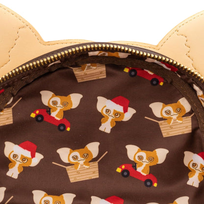 Patterned fabric with Gremlins Gizmo Holiday character on a brown background