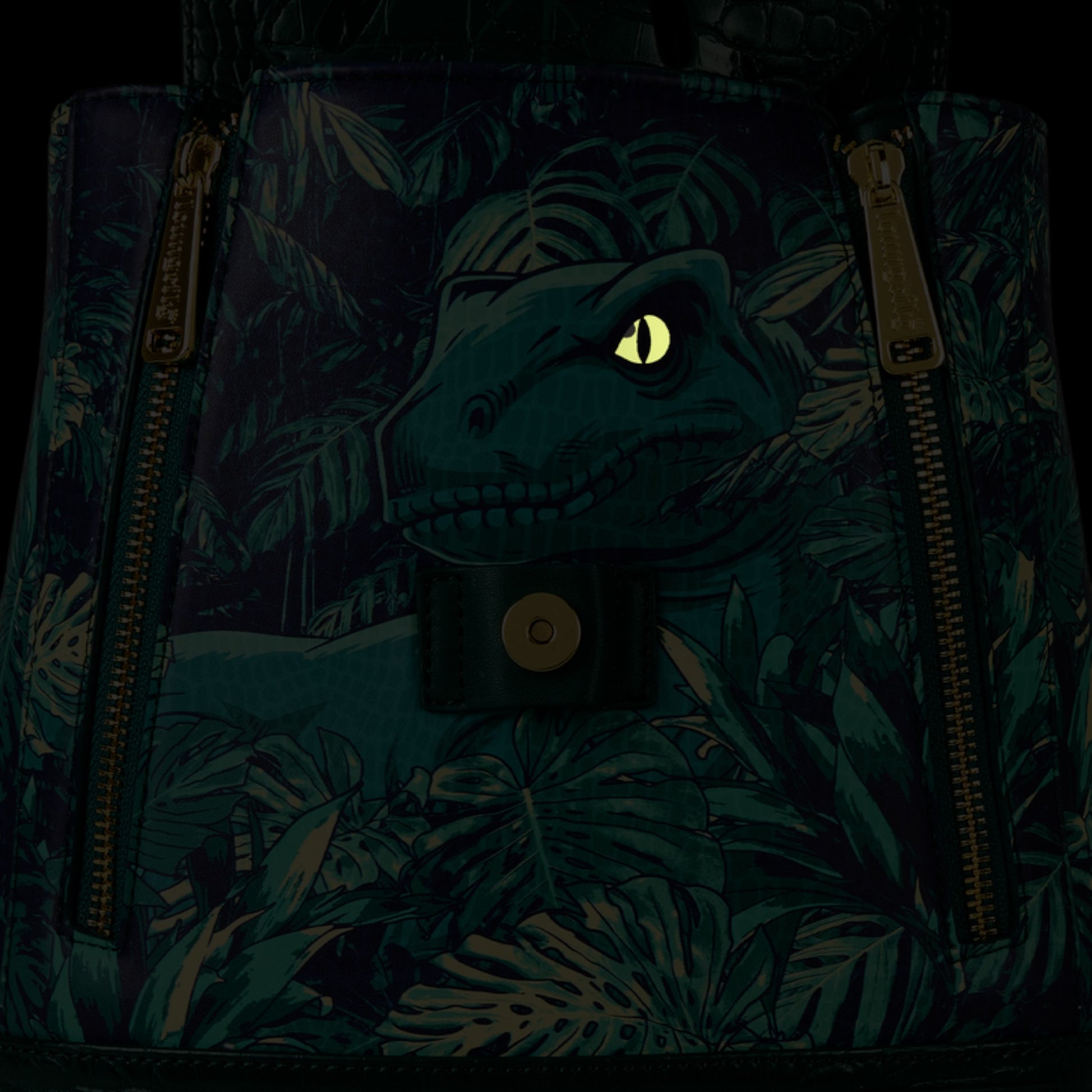 Glowing Loungefly New Jurassic World Jungle Velociraptor Glow Drawstring Mini Backpack with leaf foliage flap and eye peeking out of hole on a black background