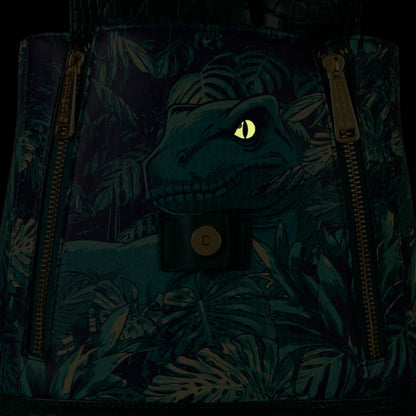 Glowing Loungefly New Jurassic World Jungle Velociraptor Glow Drawstring Mini Backpack with leaf foliage flap and eye peeking out of hole on a black background