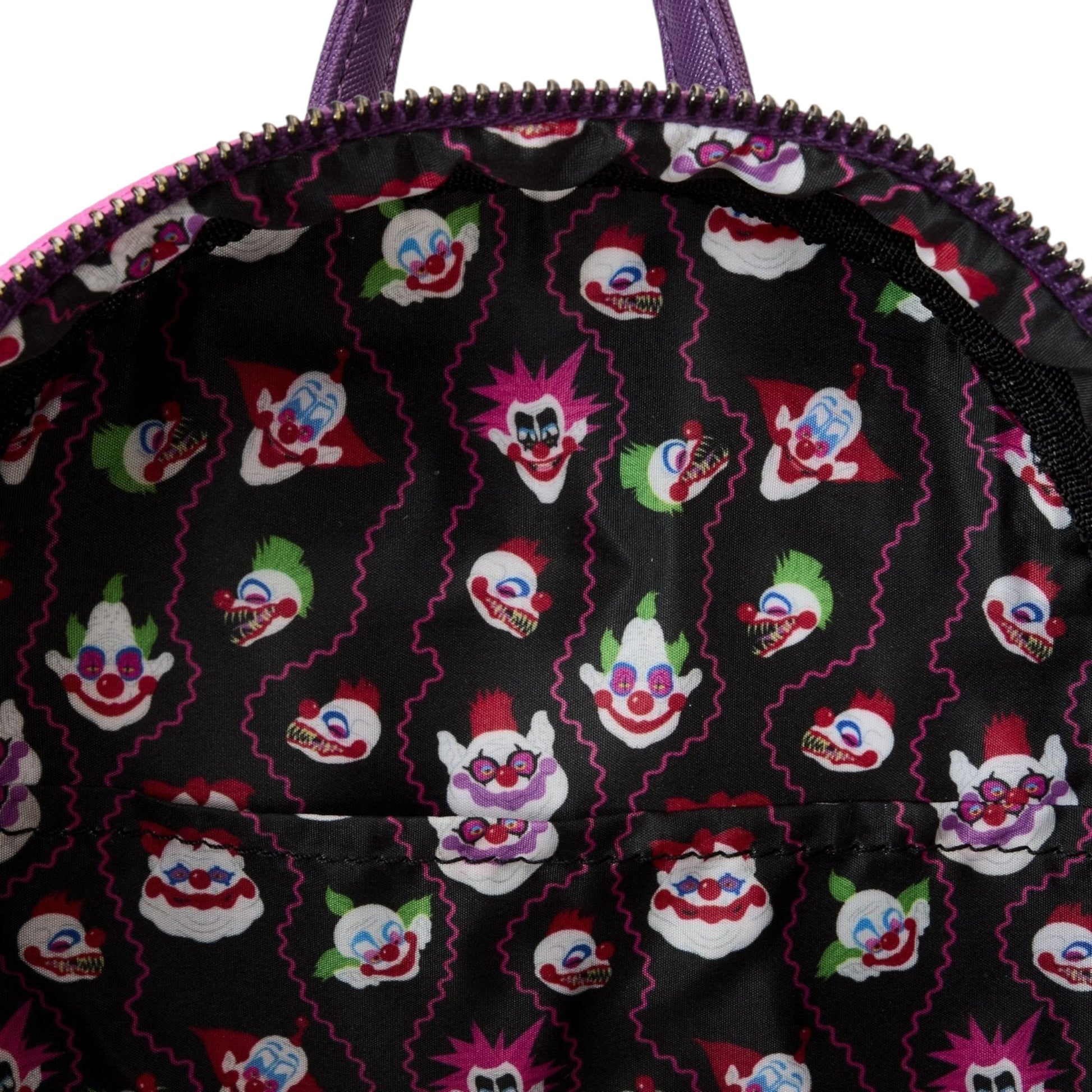 Inside of Loungefly Killer Klowns from Outer Space Jumbo Cosplay Mini Backpack with clown face character pattern on a black background