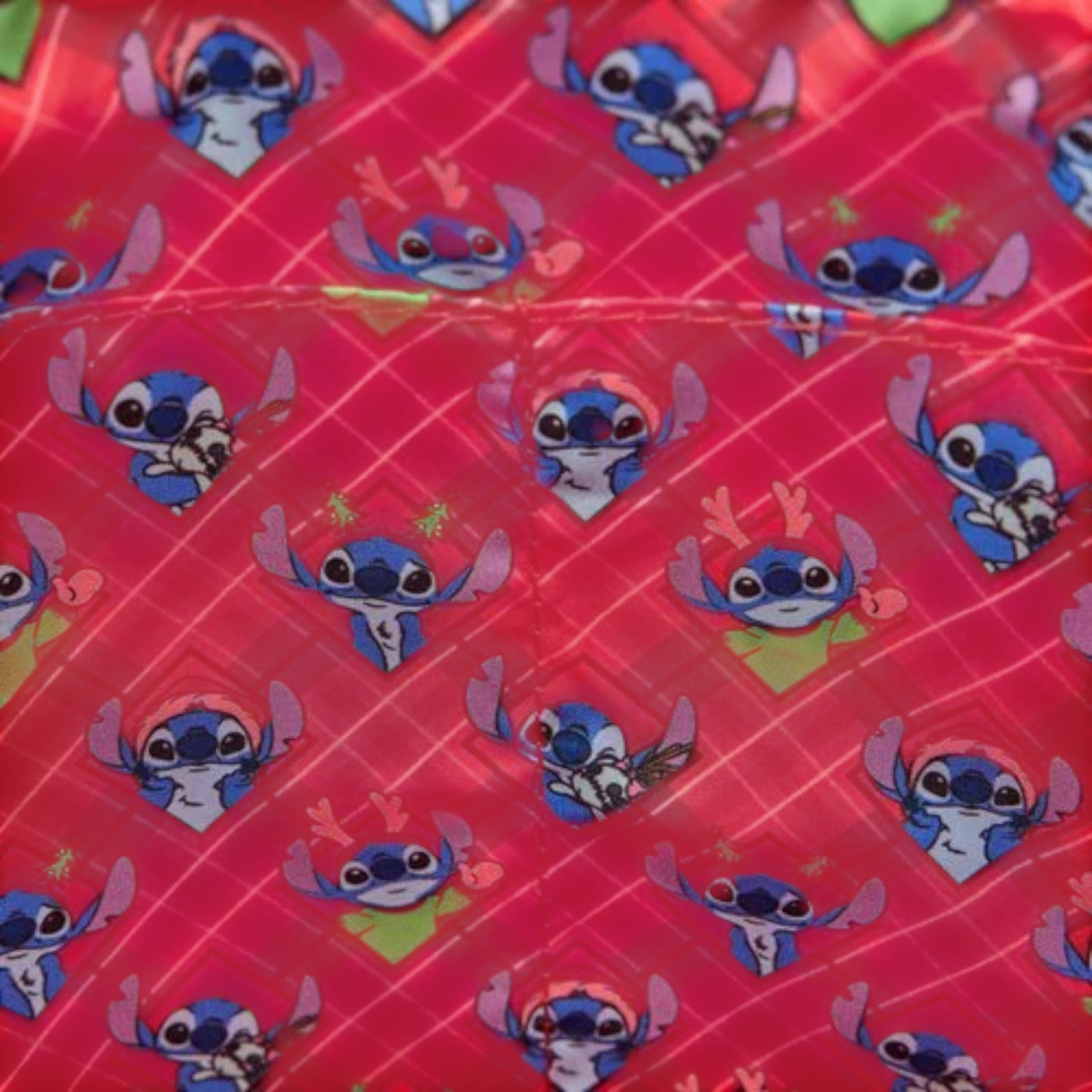 Fabric with stitch character pattern on a red background