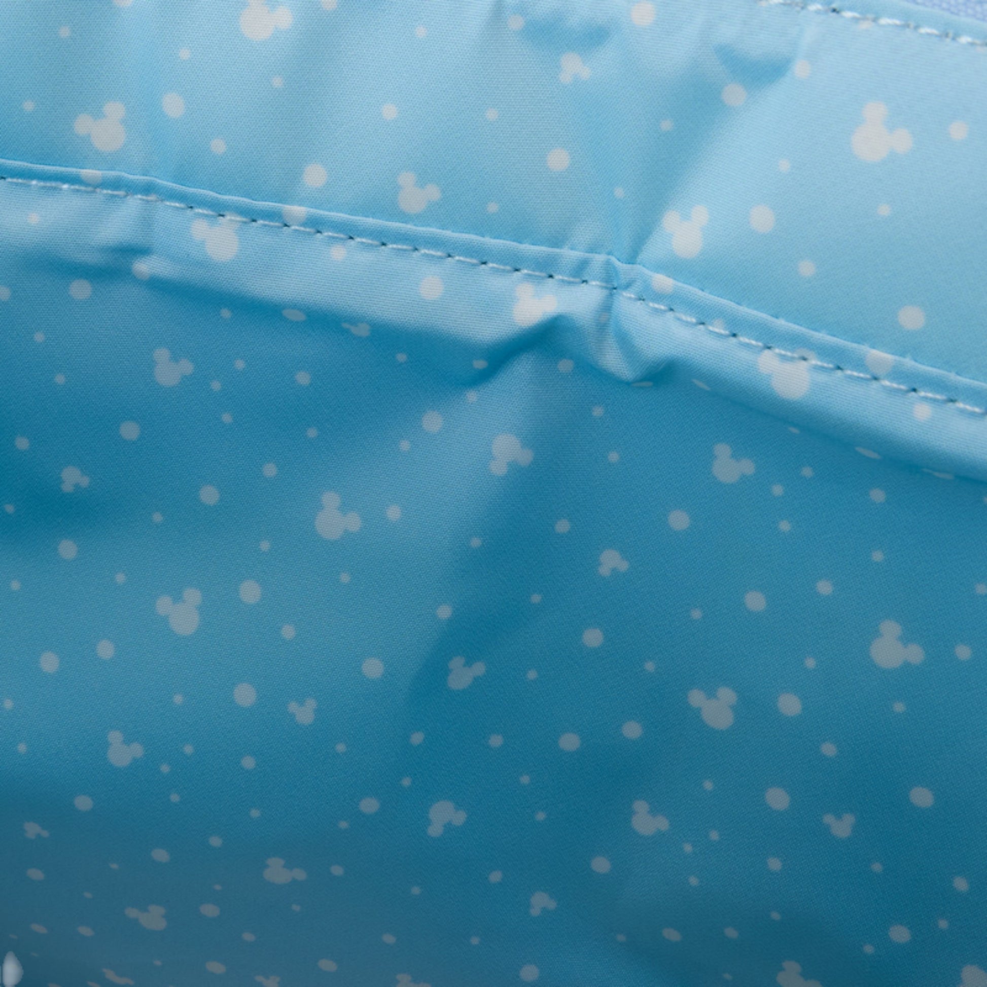 Close-up of blue fabric with white mickey head pattern