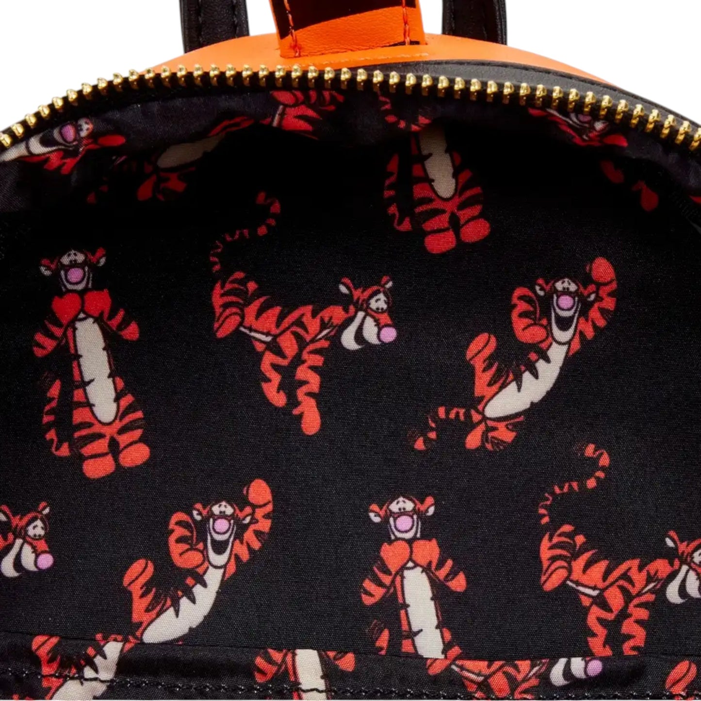 Close-up of inside of Loungefly Disney Winnie the Pooh Tigger Cosplay Mini Backpack with Tigger character patterns on a black background