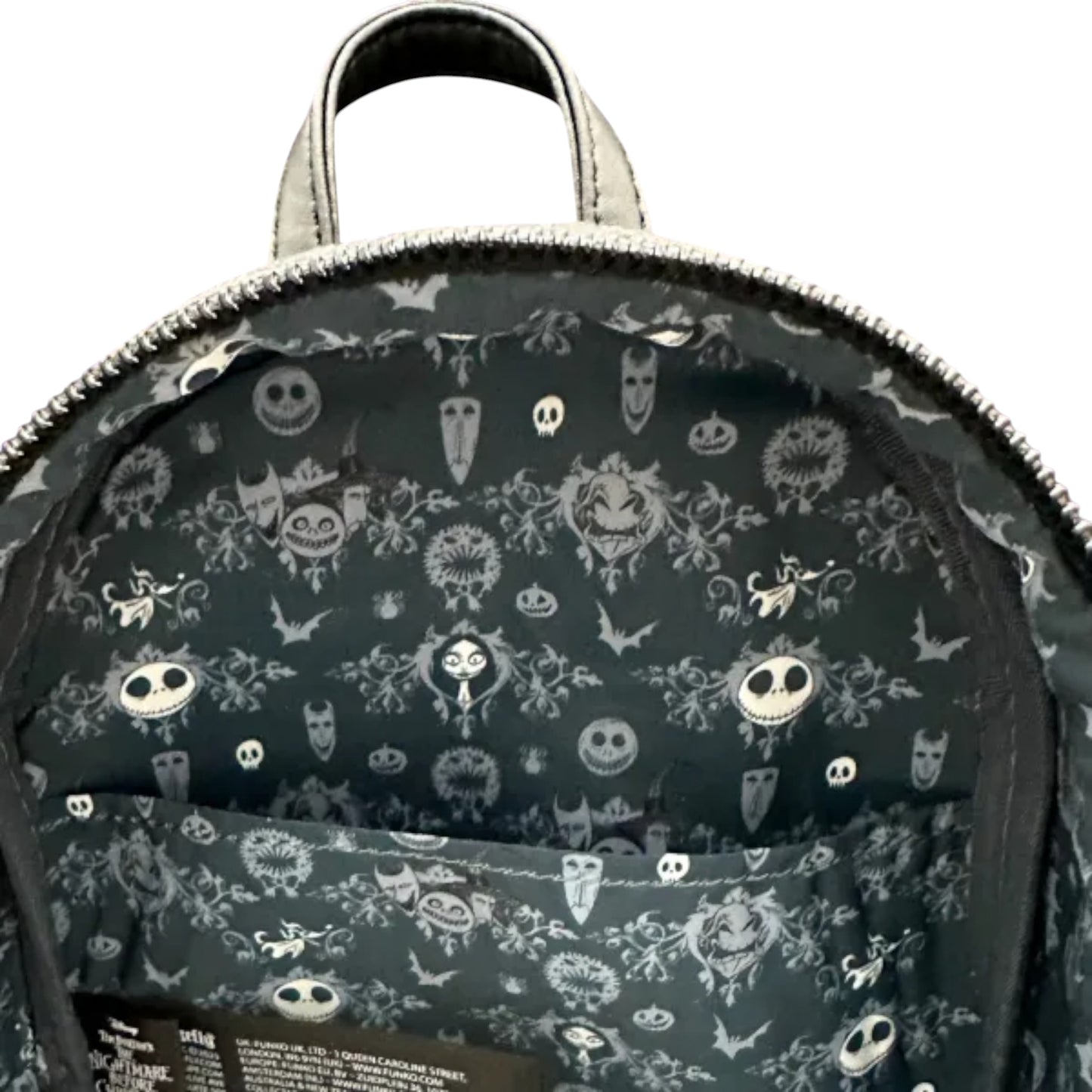 Backpack with a black and white nightmare before christmas character pattern on a dark background