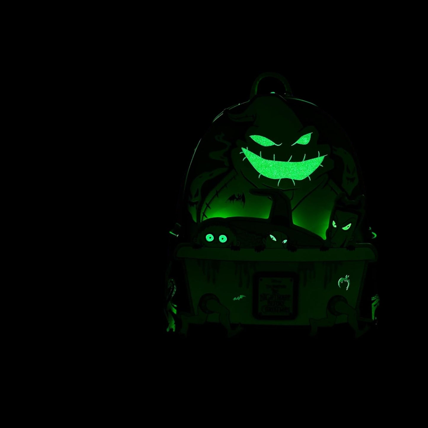 Glowing green Oogie Boogie Lock Shock and Barrel Backpack in a dark setting