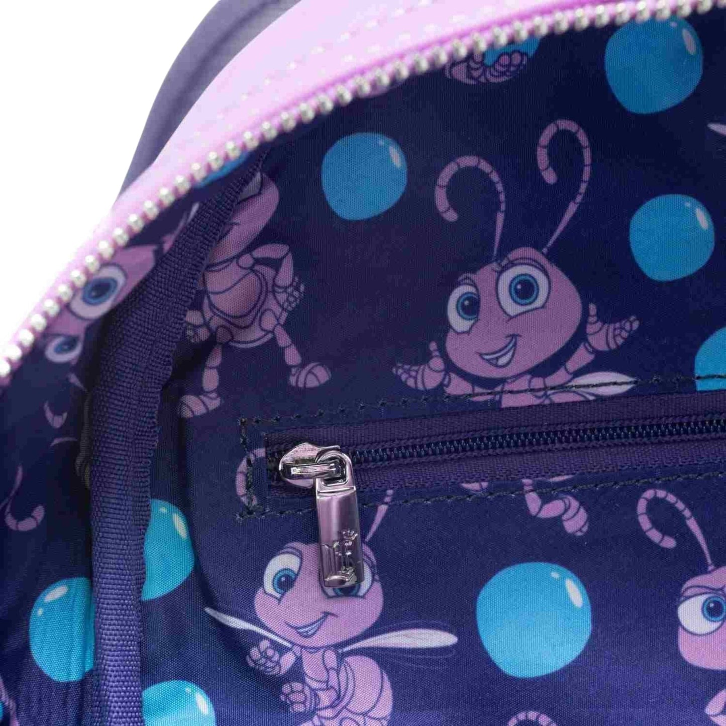 Inside of Loungefly Pixar A Bug's Life Princess Dot Cosplay Mini Backpack with Princess Dot character patterns  on a white background