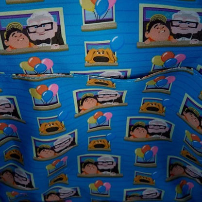 Inside of Loungefly Pixar Up Carl and Russell Mini Backpack with blue fabric with movie character and balloon patterns on a blue background