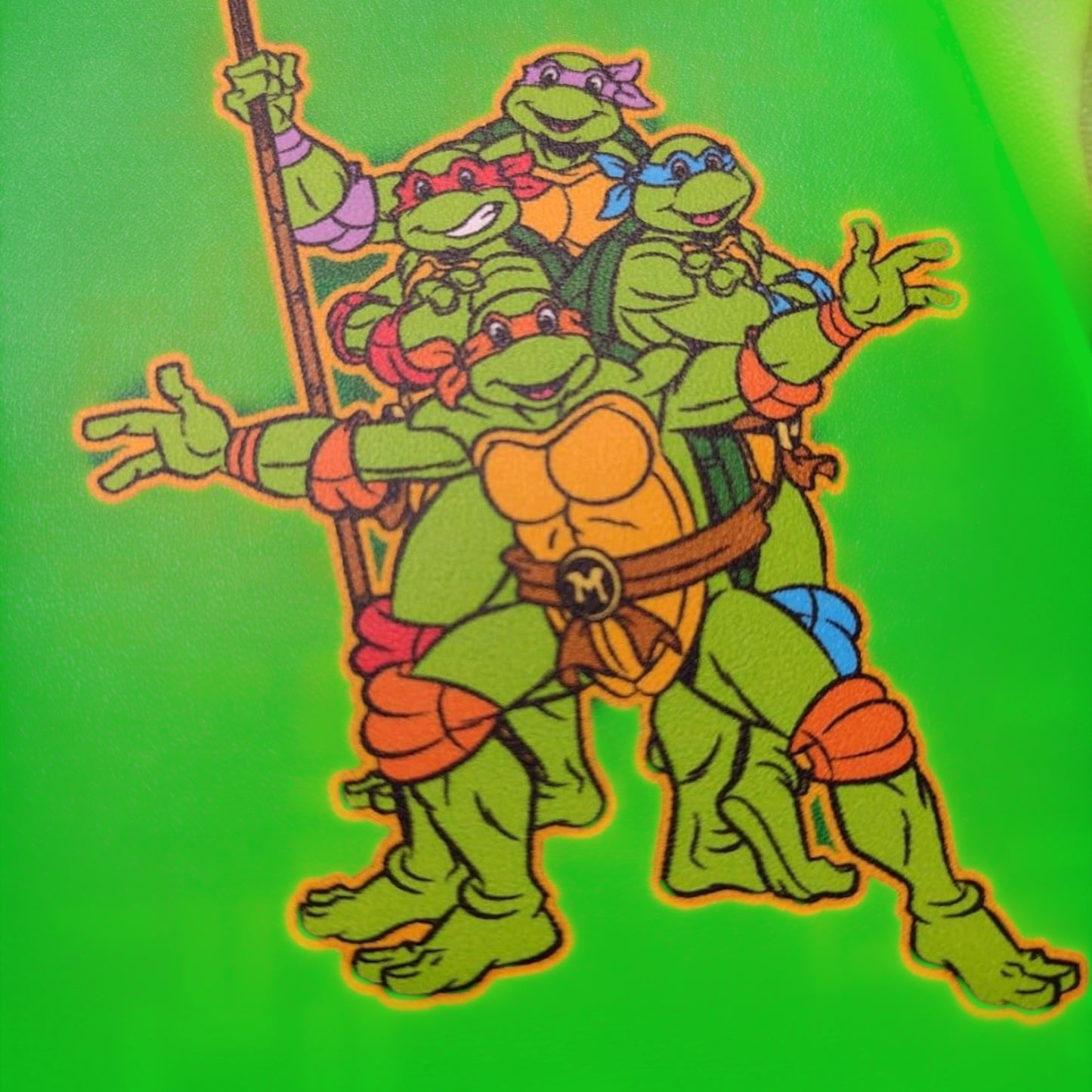 Cartoon illustration of Teenage Mutant Ninja Turtles Squad turtles with orange shells on a green background