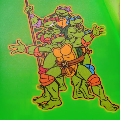 Cartoon illustration of Teenage Mutant Ninja Turtles Squad turtles with orange shells on a green background