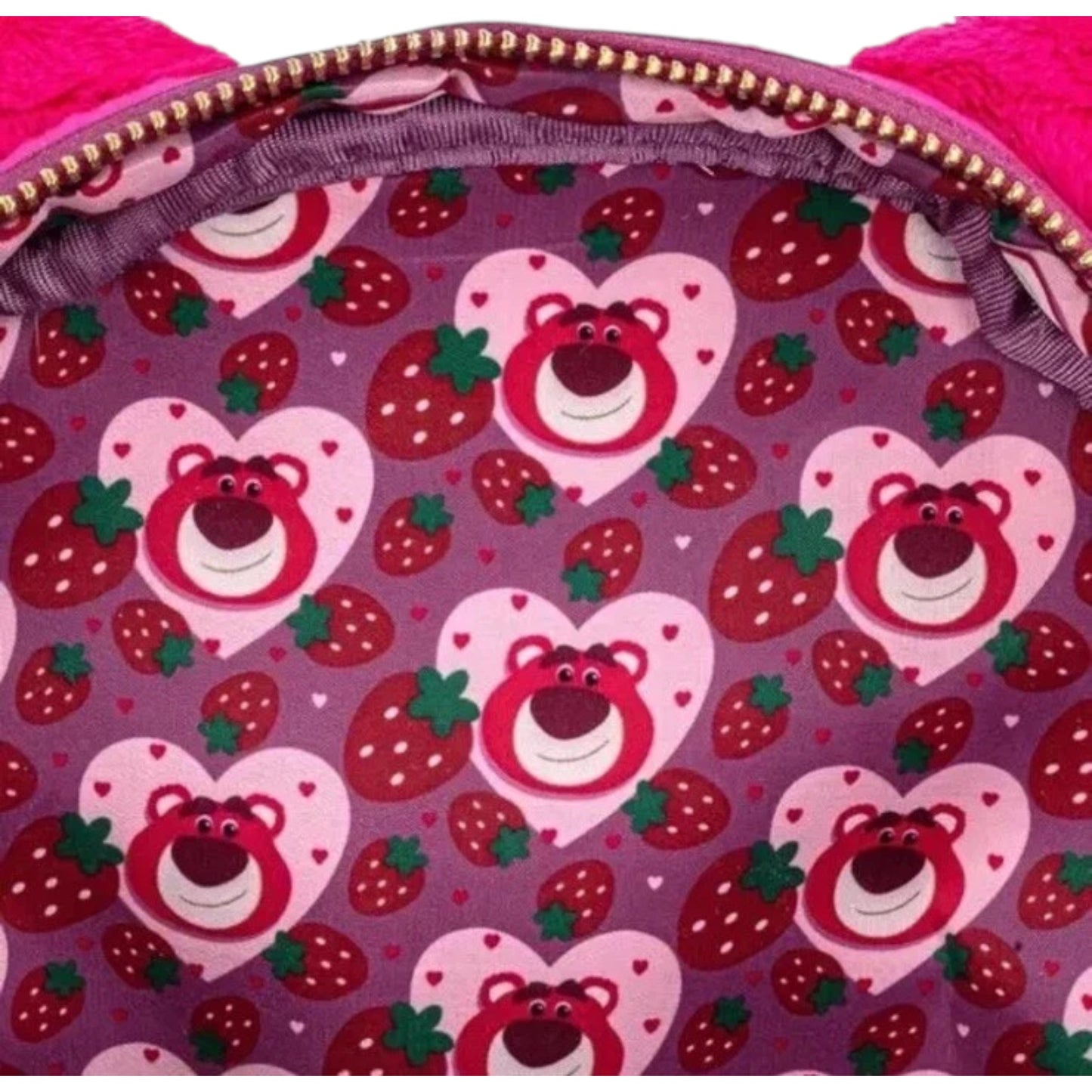 Backpack interior with heart-shaped Lotso teddy bear and strawberry pattern on a purple background