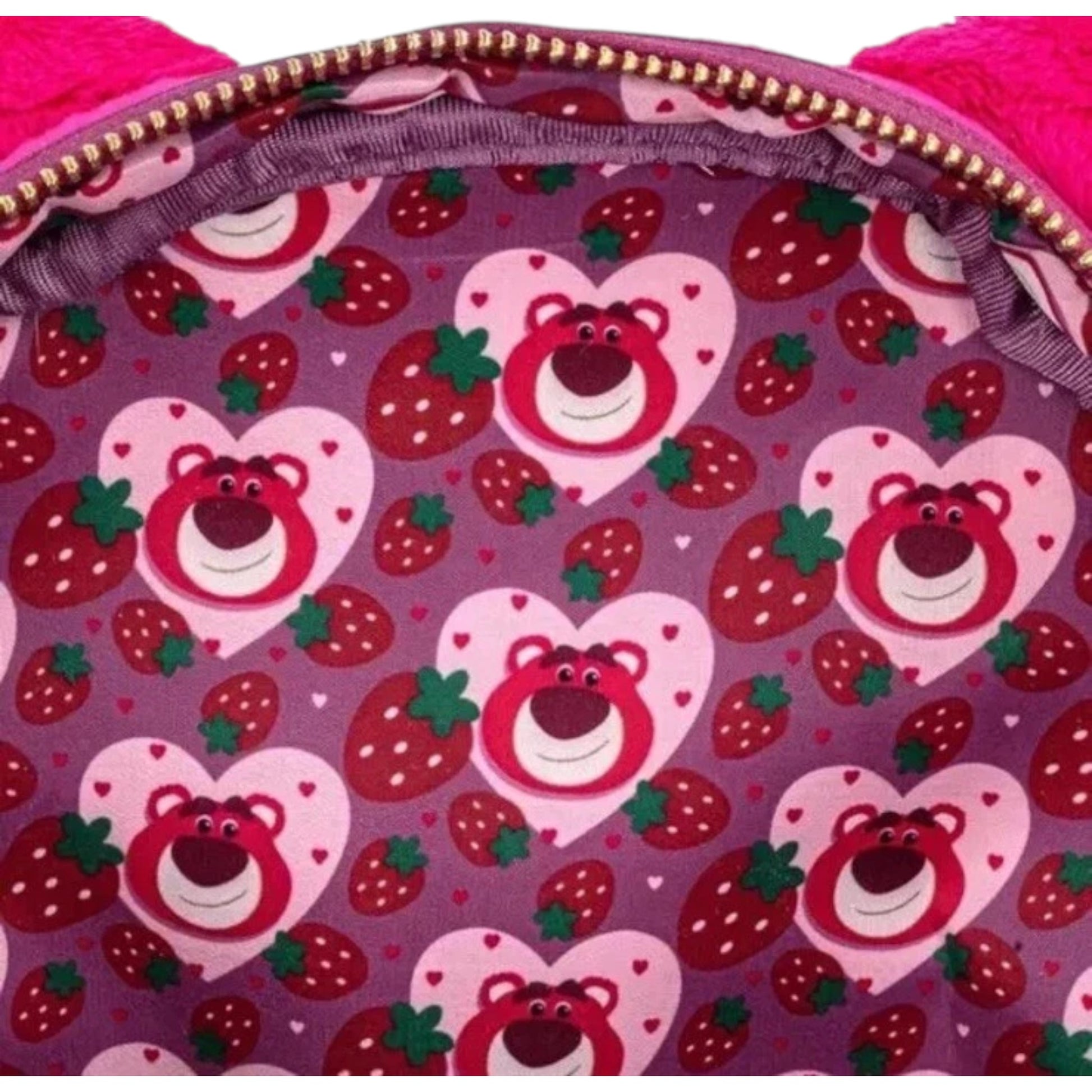 Backpack interior with heart-shaped Lotso teddy bear and strawberry pattern on a purple background