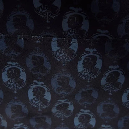 Inside of Loungefly Universal Monsters Dracula & Frankenstein Crossbody Bag with dark fabric with a pattern of Dracula & Frankenstein silhouettes in a repeat design