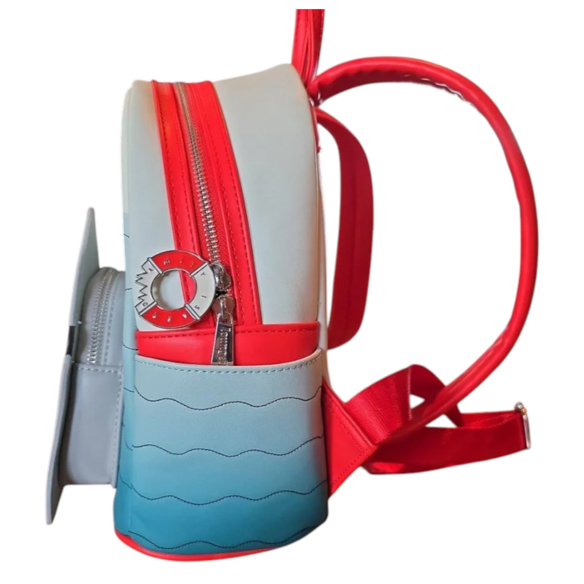 Side of Loungefly Universal Studios Jaws Mini Backpack with red and blue design and a innertube with a bite out of it zipper charm on a white background