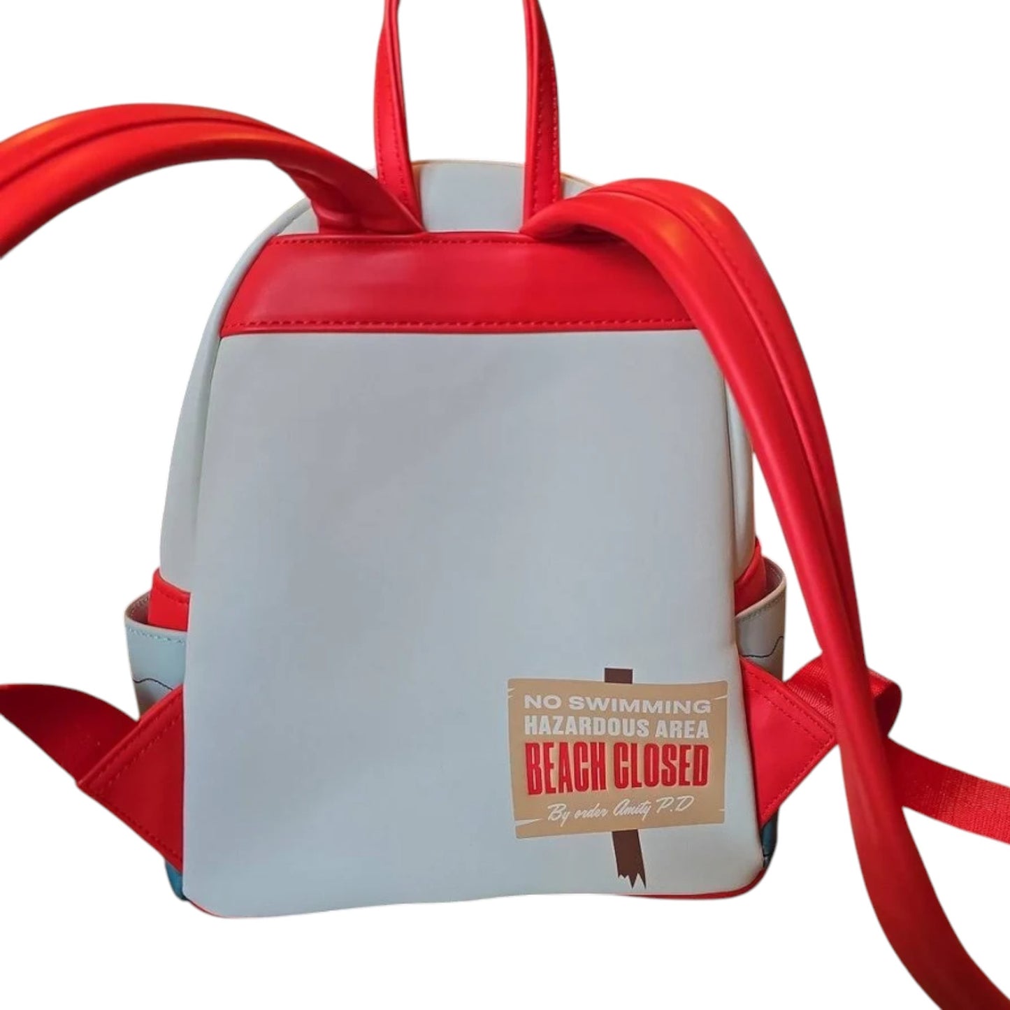 Back of Loungefly Universal Studios Jaws Mini Backpack with red straps and 'No Swimming' text on a white background