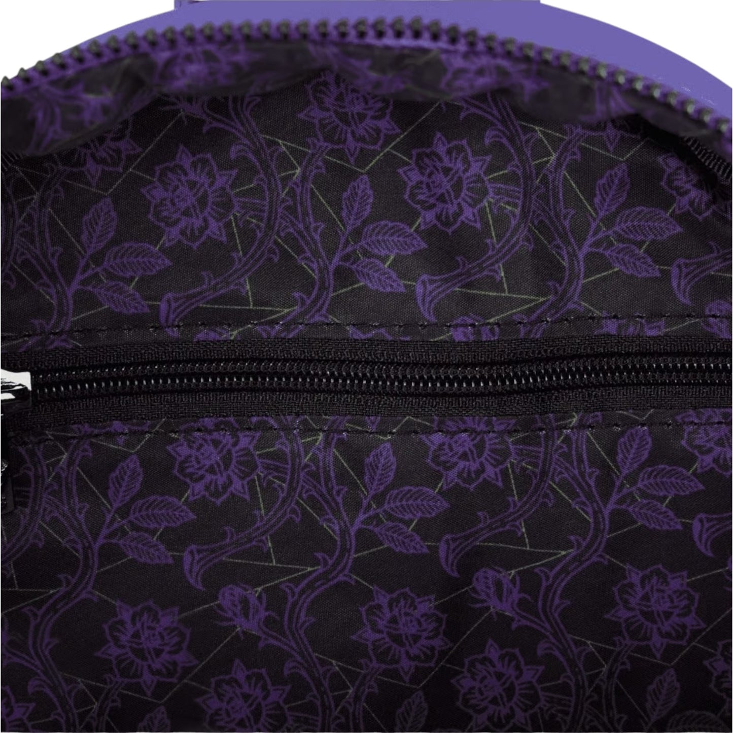 Close-up of inside of Loungefly Disney Villains Exclusive Stained Glass Glow Mini Backpack with purple floral patterned with a zipper.