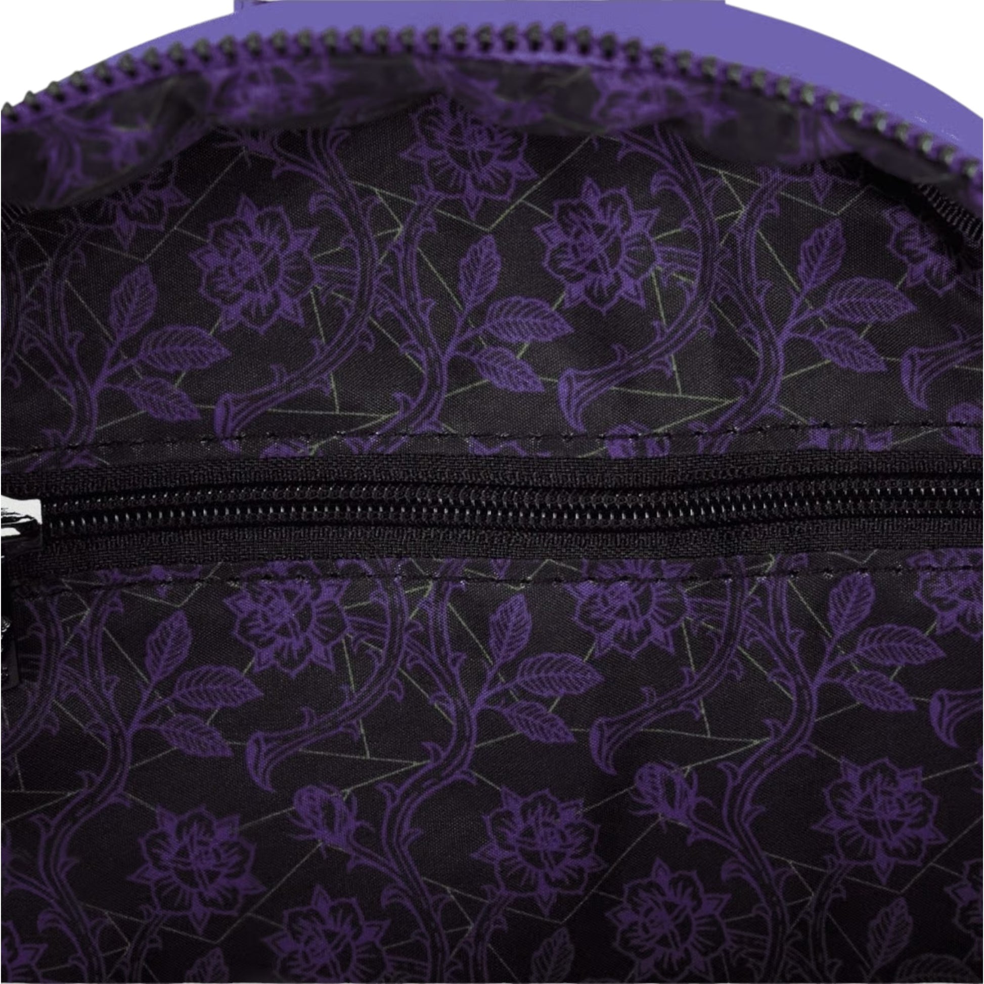Close-up of inside of Loungefly Disney Villains Exclusive Stained Glass Glow Mini Backpack with purple floral patterned with a zipper.
