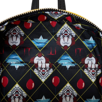 Inside Yellow Loungefly Warner Brothers IT Pennywise Raincoat Cosplay Glow Mini Backpack with a pattern of Pennywise faces and red balloons on a black background