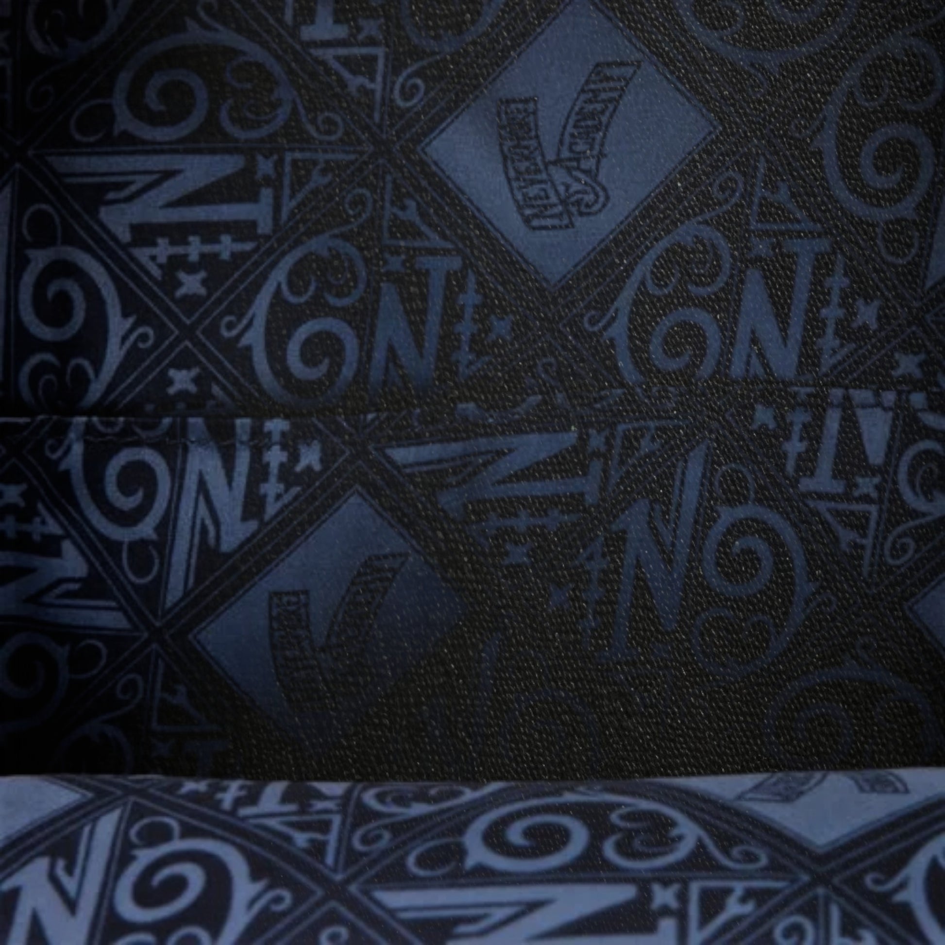 Dark fabric with blue geometric pattern and 'N' text