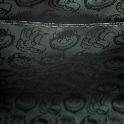 Dark fabric with printed pattern of Where the Wild Things Are faces and shapes