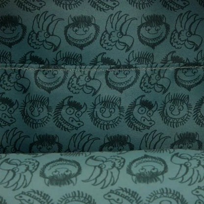 Textile with black pattern of Where the Wild Things Are character faces on a blue background
